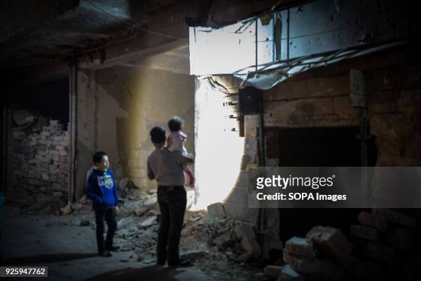 Boy uses a torch to search through rubble in the decimated Ansari al Sharki, which was held for years by rebel forces. Aleppo used to be the largest...