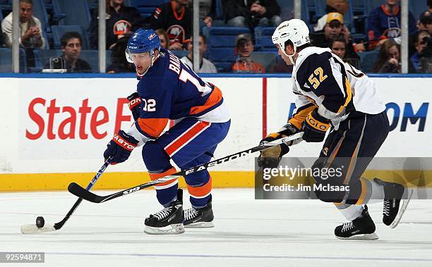 Josh Bailey of the New York Islanders skates against Craig Rivet of the Buffalo Sabres on October 31, 2009 at Nassau Coliseum in Uniondale, New York....