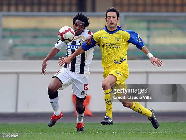 Andrea Mantovani of AC Chievo Verona competes for the ball with Juang Cuadrado of Udinese Calcio during the Serie A match between AC Chievo Verona...