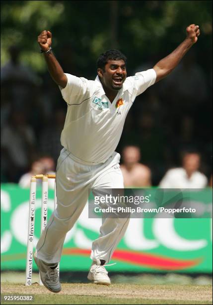 Muttiah Muralitharan of Sri Lanka celebrates after getting the wicket of England batsman Paul Collingwood , taking him to a record 709 Test wickets,...