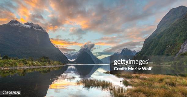 mitre peak reflecting in the water, sunset, milford sound, fiordland national park, te anau, southland region, southland, new zealand - te anau stock pictures, royalty-free photos & images