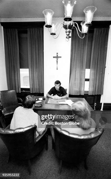 Fr. Ronald Coyne listens to a couples' questions during a pre-marriage counseling session in the rectory at St. Margaret's Church in the Dorchester...