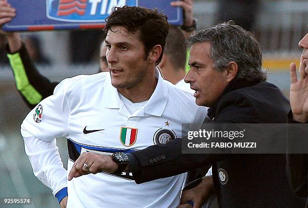 Inter's coach Jose Mourinho speaks with his player Javier Zanetti of Argentina during their serie A football match at Armando Picchi stadium in...