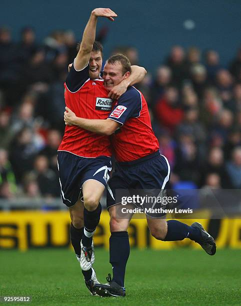 Robbie Williams celebrates his goal with Anthony Pilkiington during the Coca-Cola League One match between Oldham Athletic and Huddersfield Town at...