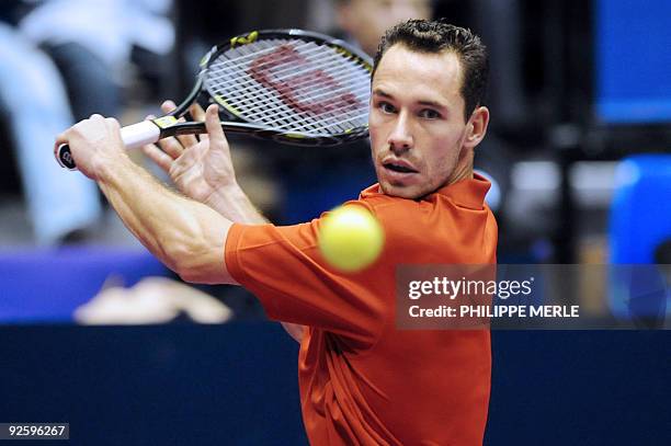 French tennis player Michael Llodra hits a backhand against his Croatia's opponent during the Lyon tennis Grand Prix final match on November 1, 2009...