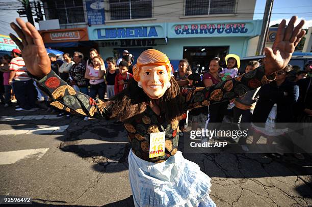 Reveller fancy-dressed as a granny cheers during the traditional "Convite de fieros" festival, part of the All Saints Day celebrations, in Villa...