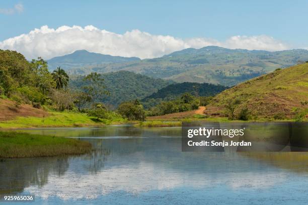 lake in front of mountain landscape, near san luis de grecia, alajuela province, costa rica - alajuela province stock-fotos und bilder