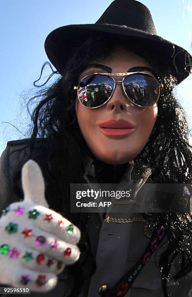 Reveller in costume of Michael Jackson dances during the traditional "Convite de fieros" festival, part of the All Saints Day celebrations, in Villa...