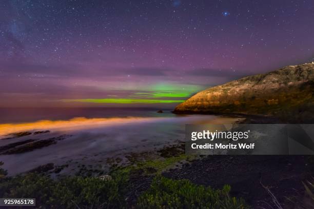 southern lights, aurora australis over the sea, sand dunes, second beach, dunedin, otago, southland, new zealand - aurora australis stock pictures, royalty-free photos & images