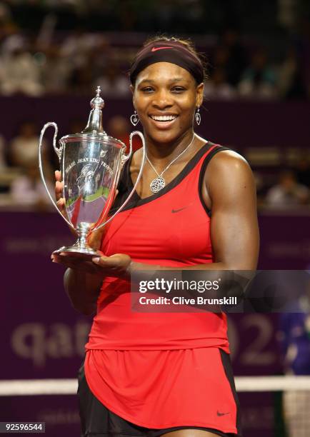 Serena Williams of the USA holds aloft the Billie Jean King trophy after her straight sets victory against Venus Williams of the USA in the Women's...