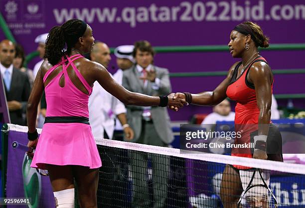 Serena Williams of the USA shakes hands at the net with Venus Williams of the USA after Serena's straight sets victory in the Women's final during...