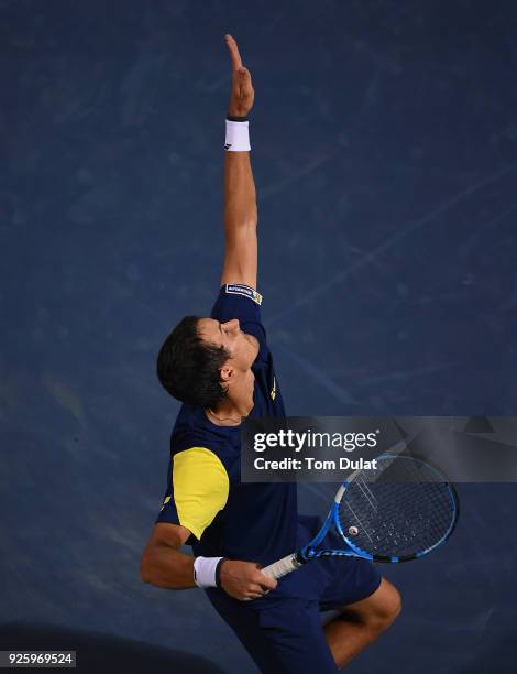 Evgeny Donskoy of Russia serves during his quarter final match against Filip Krajinovic of Serbia on day four of the ATP Dubai Duty Free Tennis...