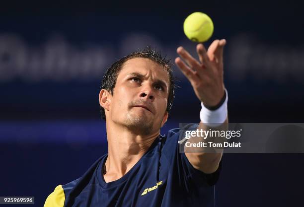 Evgeny Donskoy of Russia serves during his quarter final match against Filip Krajinovic of Serbia on day four of the ATP Dubai Duty Free Tennis...