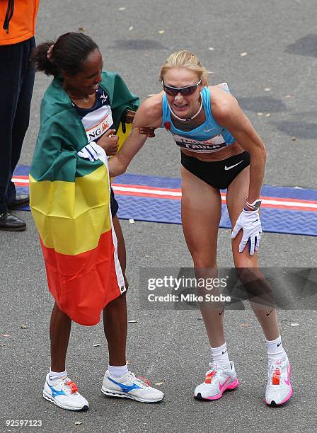 Paula Radcliffe of Great Britain is helped by the 40th ING New York City Marathon womens winner Derattu Tulu of Ethiopia on November 1, 2009 in New...