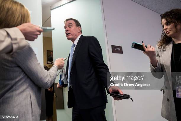 Sen. Mark Warner talks with reporters as he arrives for a closed-door meeting of the Senate Intelligence Committee, March 1, 2018 in Washington, DC....