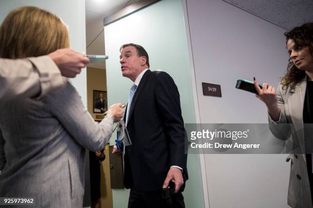 Sen. Mark Warner talks with reporters as he arrives for a closed-door meeting of the Senate Intelligence Committee, March 1, 2018 in Washington, DC....