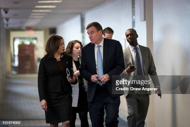 Sen. Kamala Harris walks with Sen. Mark Warner as they arrive for a closed-door meeting of the Senate Intelligence Committee, March 1, 2018 in...
