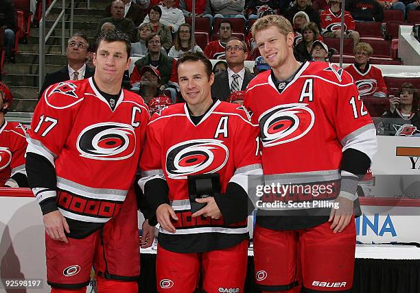 Ray Whitney of the Carolina Hurricanes is congratulated by teammates Rod Brind'Amour and Eric Staal during a pre-game ceremony at a game against the...