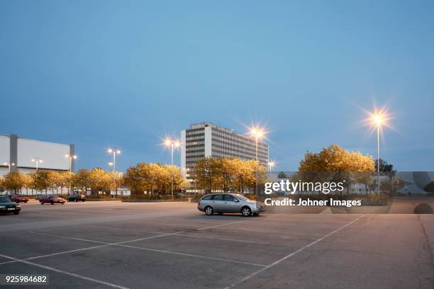 single car in parking at evening - parking stock pictures, royalty-free photos & images