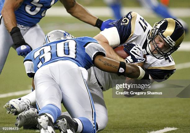 Billy Bajema of the St. Louis Rams is tackled after a third quarter catch by Ko Simpson of the Detroit Lions on November 1, 2009 at Ford Field in...