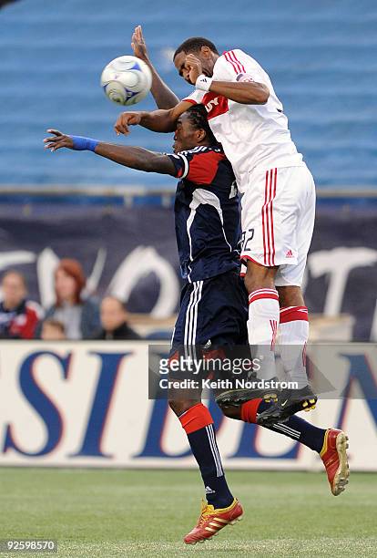 Dasan Robinson of the Chicago Fire goes over the top Shalrie Joseph on a 50-50 ball during an MLS match on November 1 at Gillette Stadium in...