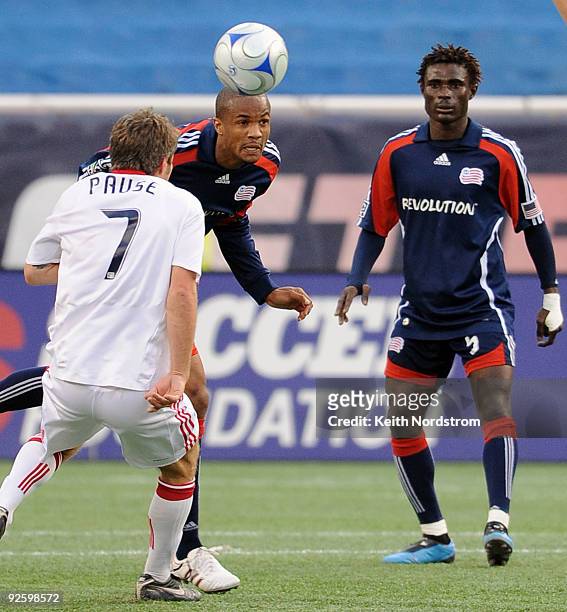 Darrius Barnes of the New England Revolution heads the ball in front of Logan Pause of the Chicago Fire during an MLS match on November 1 at Gillette...