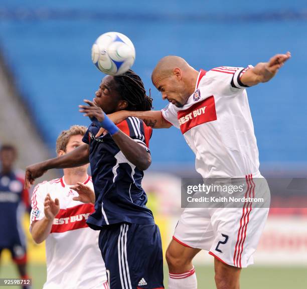 Shalrie Joseph of the New England Revolution heads the ball in front of C.J. Brown of the Chicago Fire during an MLS match on November 1 at Gillette...