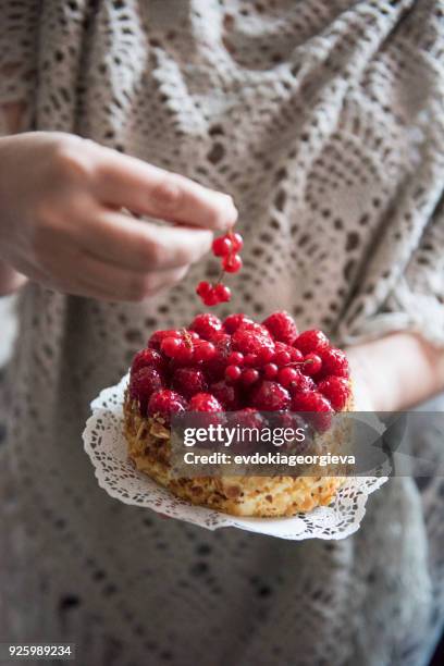 woman holding a raspberry and redcurrant cake - redcurrant stock pictures, royalty-free photos & images