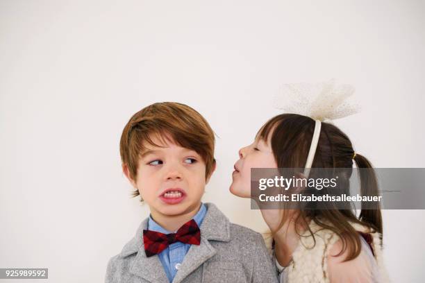 portrait of a girl trying to kiss a boy - girl blushing stock pictures, royalty-free photos & images