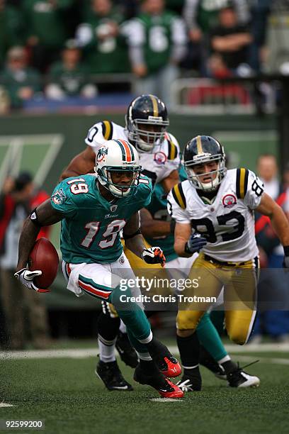 Ted Ginn of the Miami Dolphins returns a kick off during a game against the New York Jets at Giants Stadium on November 1, 2009 in East Rutherford,...