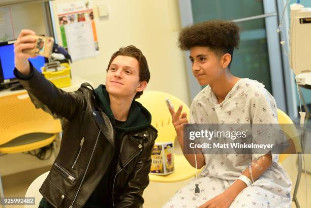 Tom Holland visits with children in support of Marvel's The Universe Unites at LAC+USC Medical Center on March 1, 2018 in Los Angeles, California....