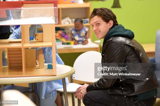 Tom Holland visits with children in support of Marvel's The Universe Unites at LAC+USC Medical Center on March 1, 2018 in Los Angeles, California....