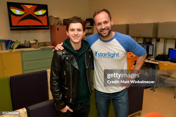 Tom Holland and Chris Helfrich visit with children in support of Marvel's The Universe Unites at LAC+USC Medical Center on March 1, 2018 in Los...