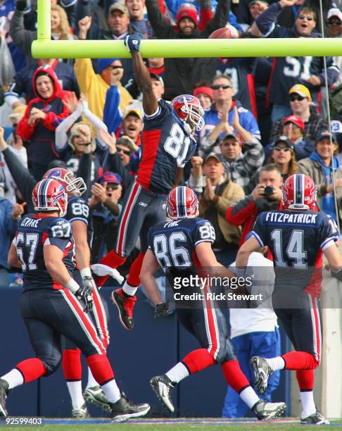 Terrell Owens of the Buffalo Bills dunks on the crossbar after scoring Buffalo's only touchdown against the Houston Texans at Ralph Wilson Stadium on...