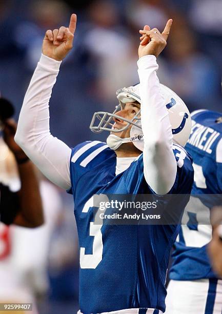 Matt Stover of the Indianapolis Colts points upward after kicking one of his 4 field goals during the NFL game against the San Francisco 49ers at...