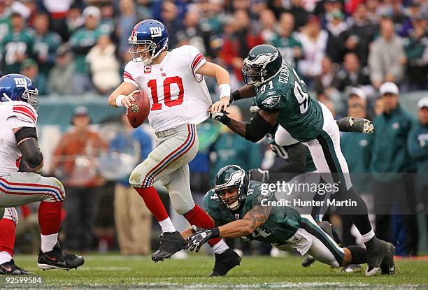 Defensive end Chris Clemons and defensive end Jason Babin of the Philadelphia Eagles sack quarterback Eli Manning of the New York Giants during a...