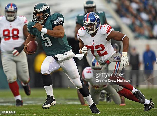 Quarterback Donovan McNabb of the Philadelphia Eagles scrambles away from defensive end Osi Umenyiora of the New York Giants on November 1, 2009 at...