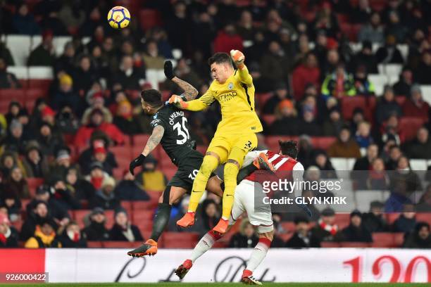 Manchester City's Brazilian goalkeeper Ederson collides with Manchester City's Argentinian defender Nicolas Otamendi during the English Premier...