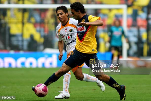 Enrique Esqueda of America vies for the ball with Christian Valdez of Jaguares during their match as part of the 2009 Opening tournament, the closing...