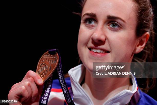 Bronze medallist Britain's Laura Muir poses on the podium during the medal ceremony for the women's 3000m at the 2018 IAAF World Indoor Athletics...