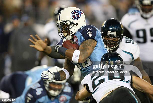 Brian Russell of the Jacksonville Jaguars tries to tackle LenDale White of the Tennessee Titans during their game at LP Field on November 1, 2009 in...