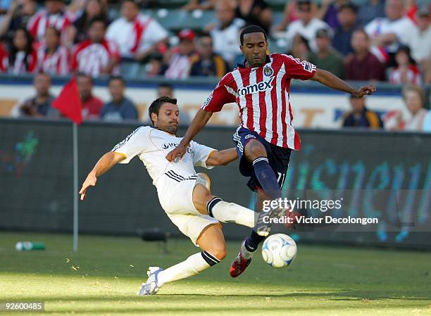 Maykel Galindo of Chivas USA plays the ball past Dema Kovalenko of the Los Angeles Galaxy in the second half during Game 1 of the MLS Western...