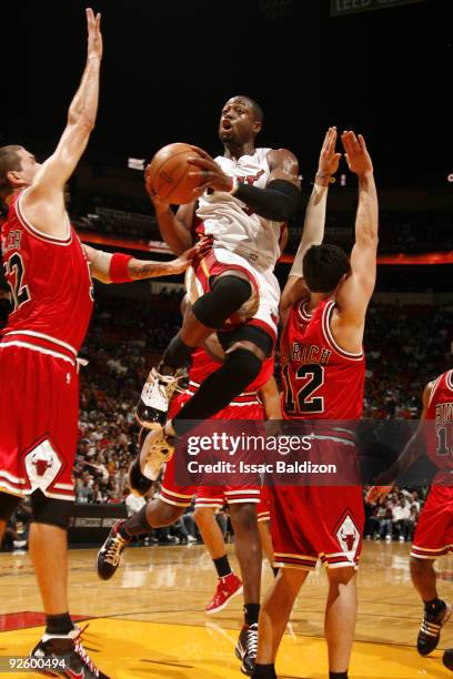 Dwyane Wade of the Miami Heat shoots against Brad Miller and Kirk Hinrich of the Chicago Bulls on November 1, 2009 at American Airlines Arena in...