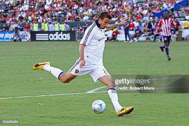 Alan Gordon of the Los Angeles Galaxy takes a shot against the defense of Chivas USA during Game One of the MLS Western Conference Semifinals at The...