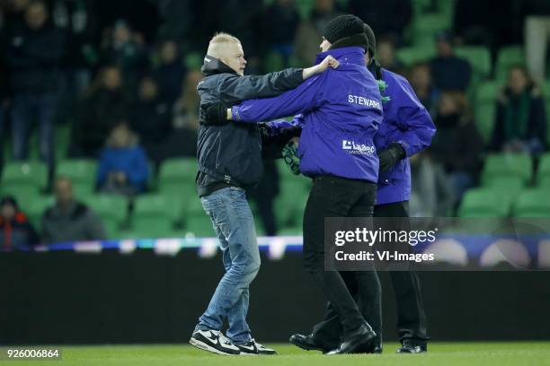 Pitch intruder with stewards during the Dutch Eredivisie match between FC Groningen and NAC Breda at Noordlease stadium on February 23, 2018 in...