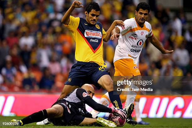 Guillermo Cerda of America vies for the ball with Javier Gandolfi and Oscar Perez of Jaguares during their match as part of the 2009 Opening...