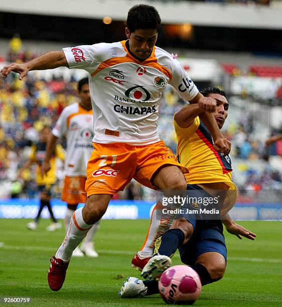 Salvador Cabanas of America vies for the ball with Cristian Valdez of Jaguares during their match as part of the 2009 Opening tournament, the closing...