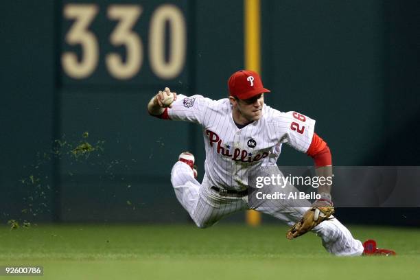 Chase Utley of the Philadelphia Phillies fails to make a throw on an infield single hit by Derek Jeter of the New York Yankees in the top of the...