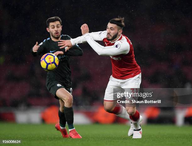 Sead Kolasinac of Arsenal gets to the ball ahead of Bernardo Silva of Manchester City during the Premier League match between Arsenal and Manchester...