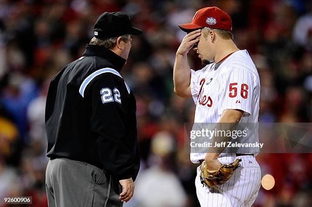 Umpire Joe West talks with starting pitcher Joe Blanton of the Philadelphia Phillies after Blanton hit Alex Rodriguez of the New York Yankees with a...